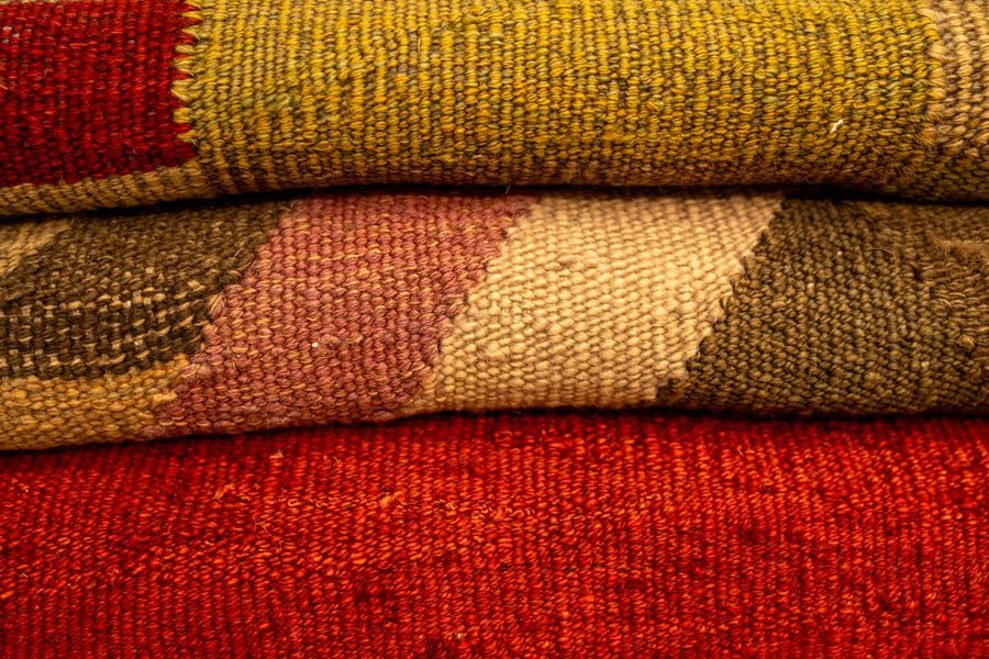 A close-up view of vibrant, textured, handwoven fabrics showcasing intricate patterns.