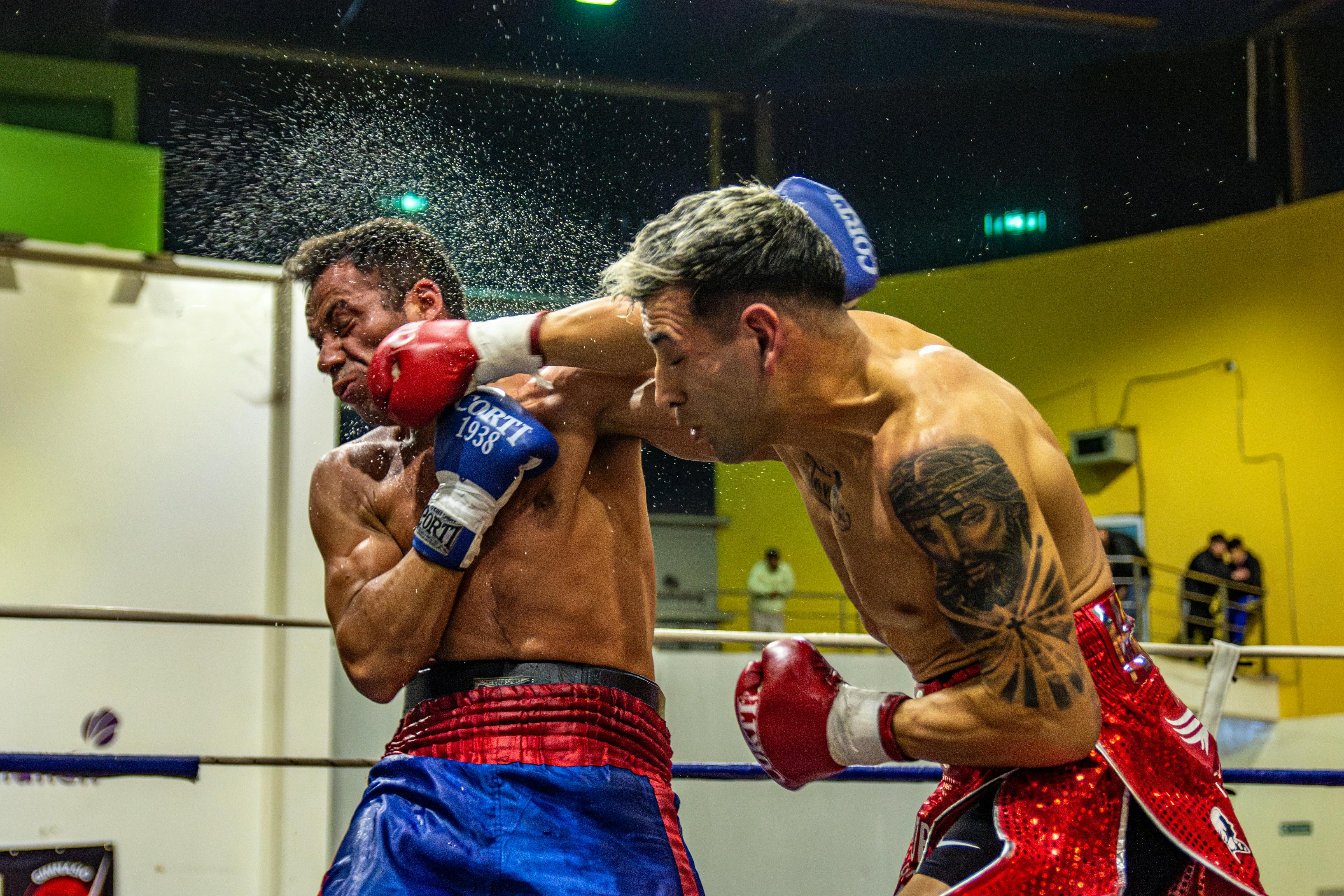 A powerful punch during a boxing match captured with dramatic detail.