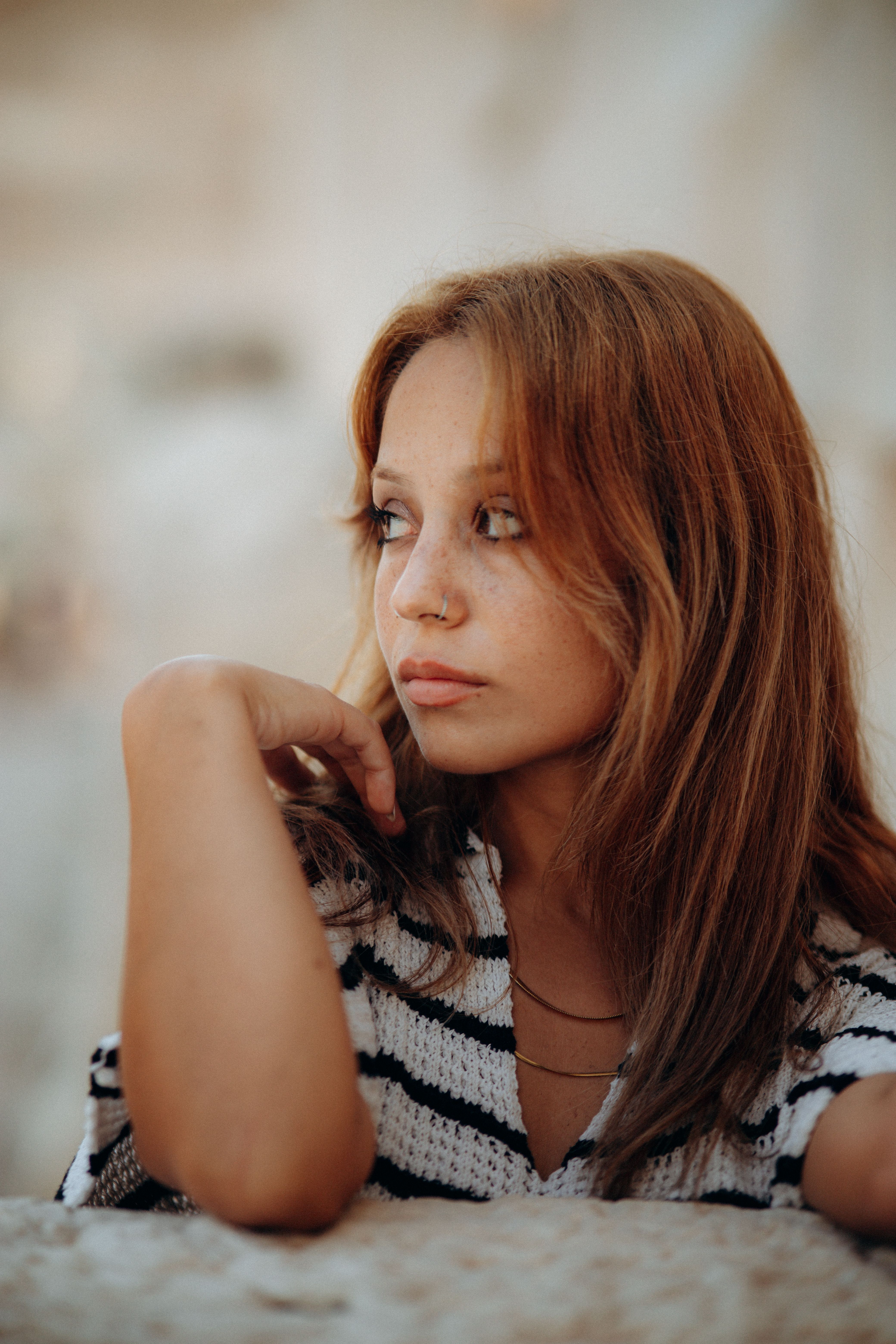 A woman with red hair looking off to the side · Free Stock Photo