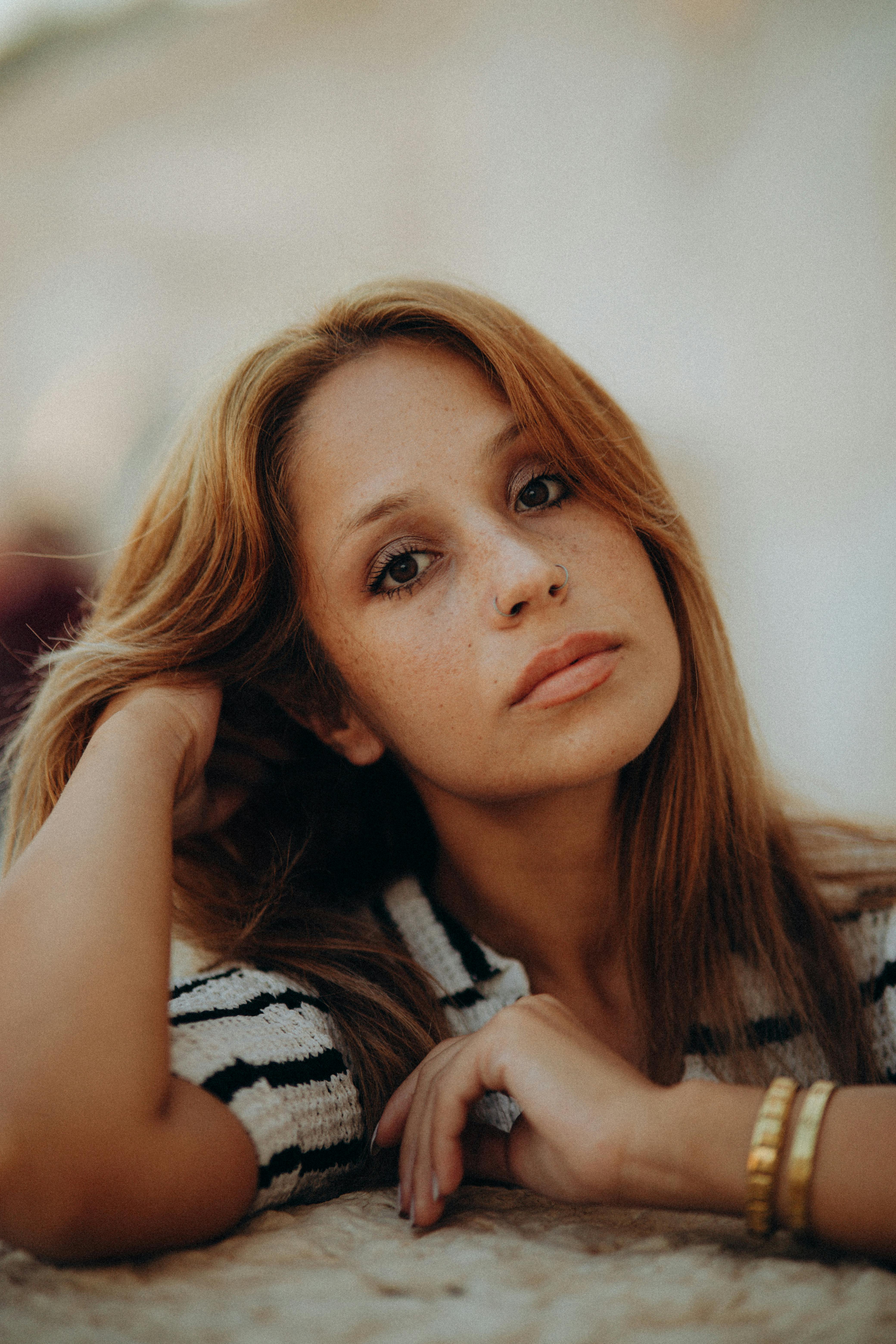 a woman with long hair and a striped shirt