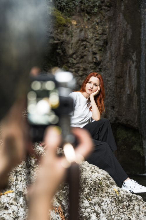 Free Elegant woman in outdoor portrait shoot amid rocky landscape, exuding leisure and sophistication. Stock Photo