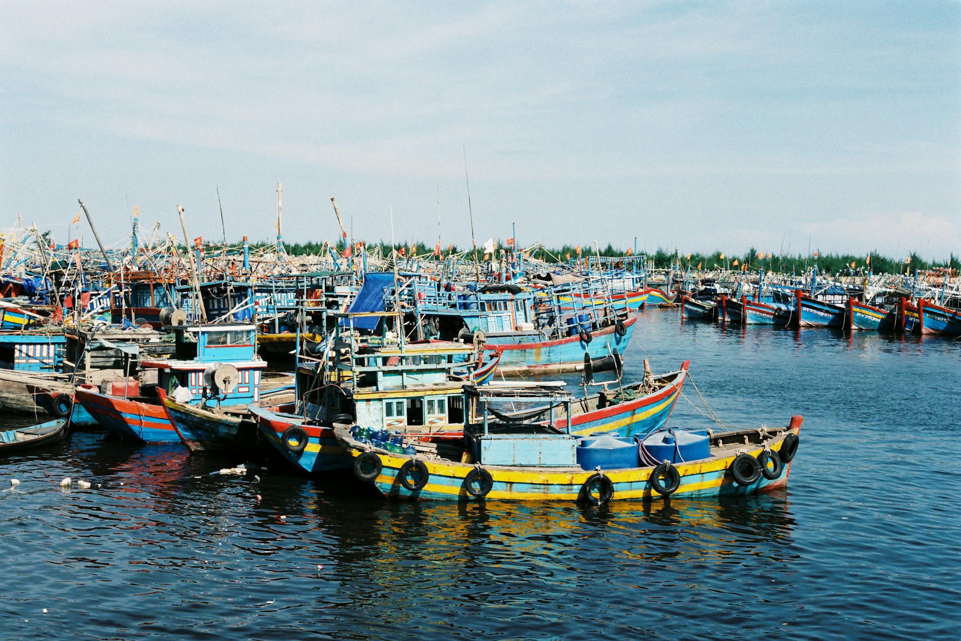 Vibrant traditional fishing boats docked at Ba Ria harbor in Vietnam, showcasing local marine culture.