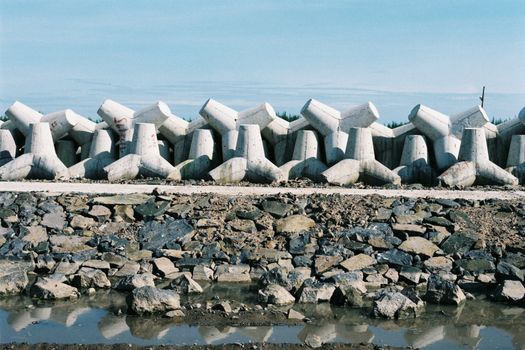 Concrete tetrapods line the shore for coastal protection in Vietnam.