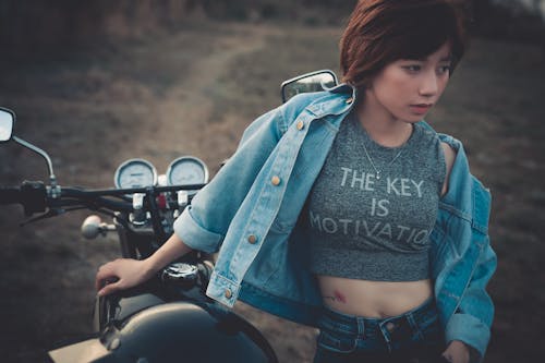 Free Photo Of Woman Standing Beside Motorcycle Stock Photo