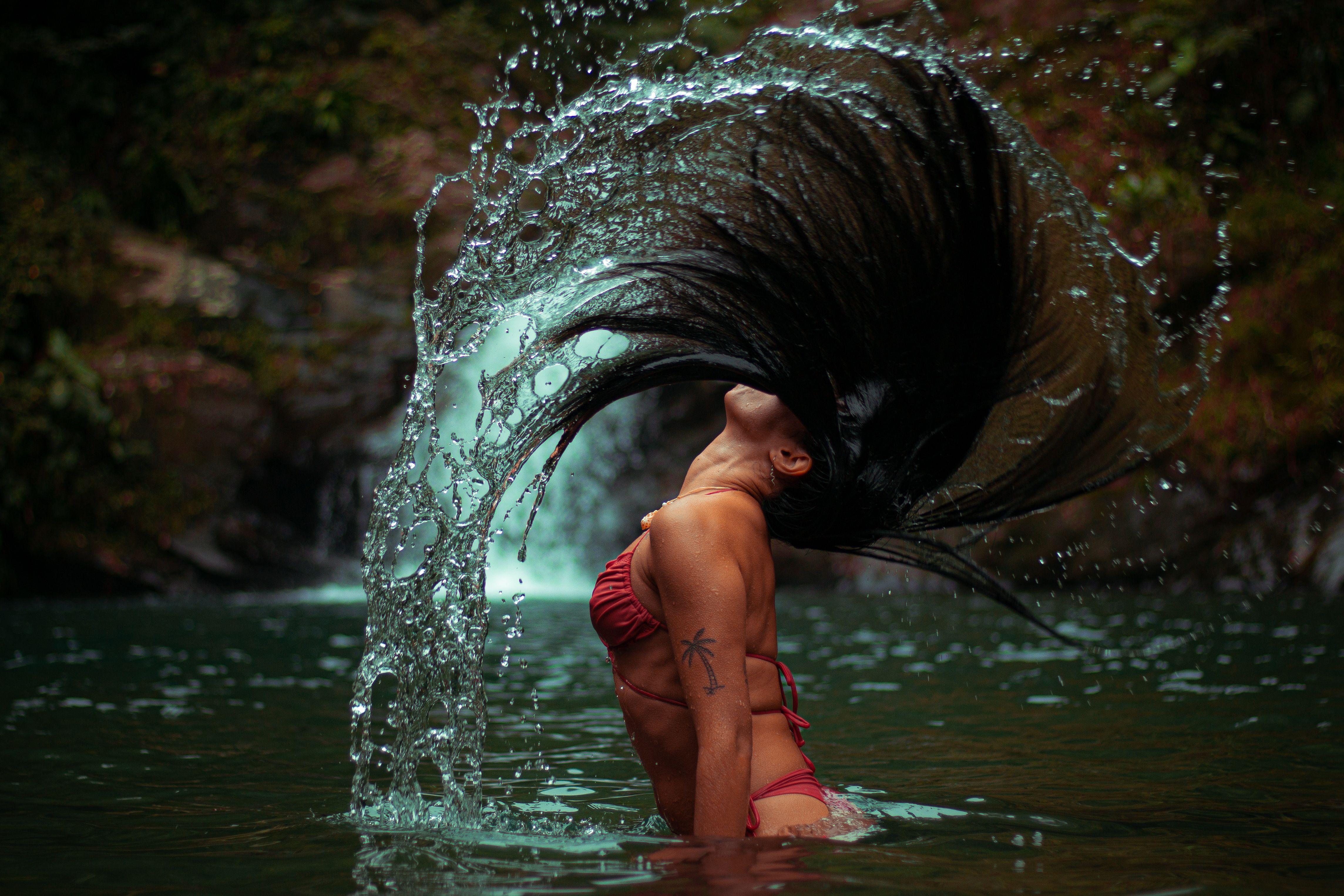 A woman with long hair in the water · Free Stock Photo