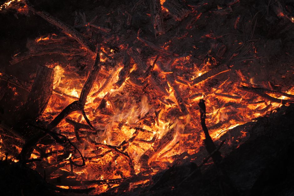 A close-up view of burning wood and intense flames emphasizing heat and destruction.