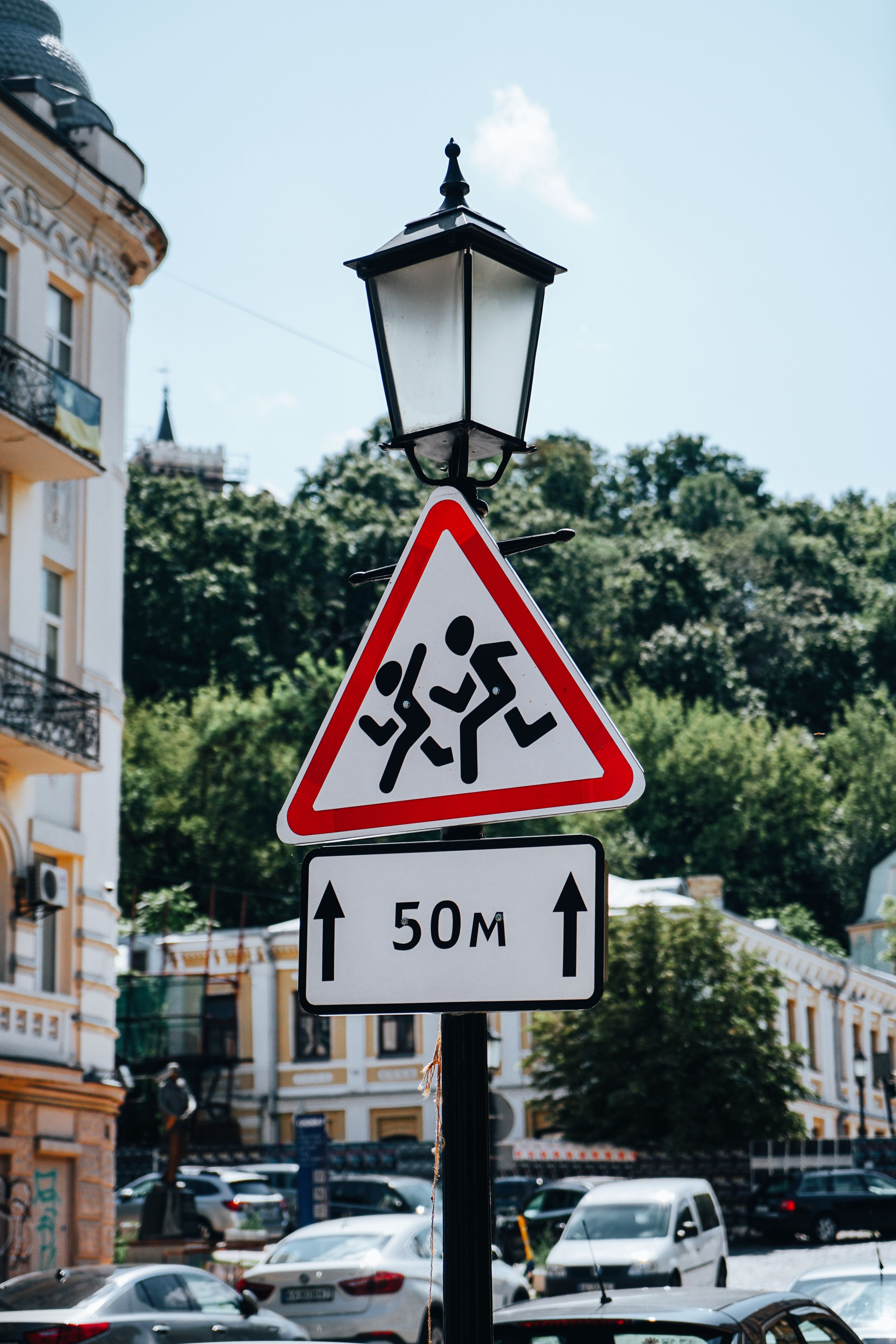 School Zone Warning Sign with Urban Backdrop · Free Stock Photo