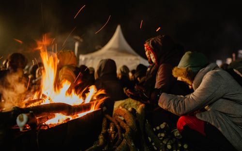Free People gather around a warming bonfire at night in Central Java's cool atmosphere. Stock Photo