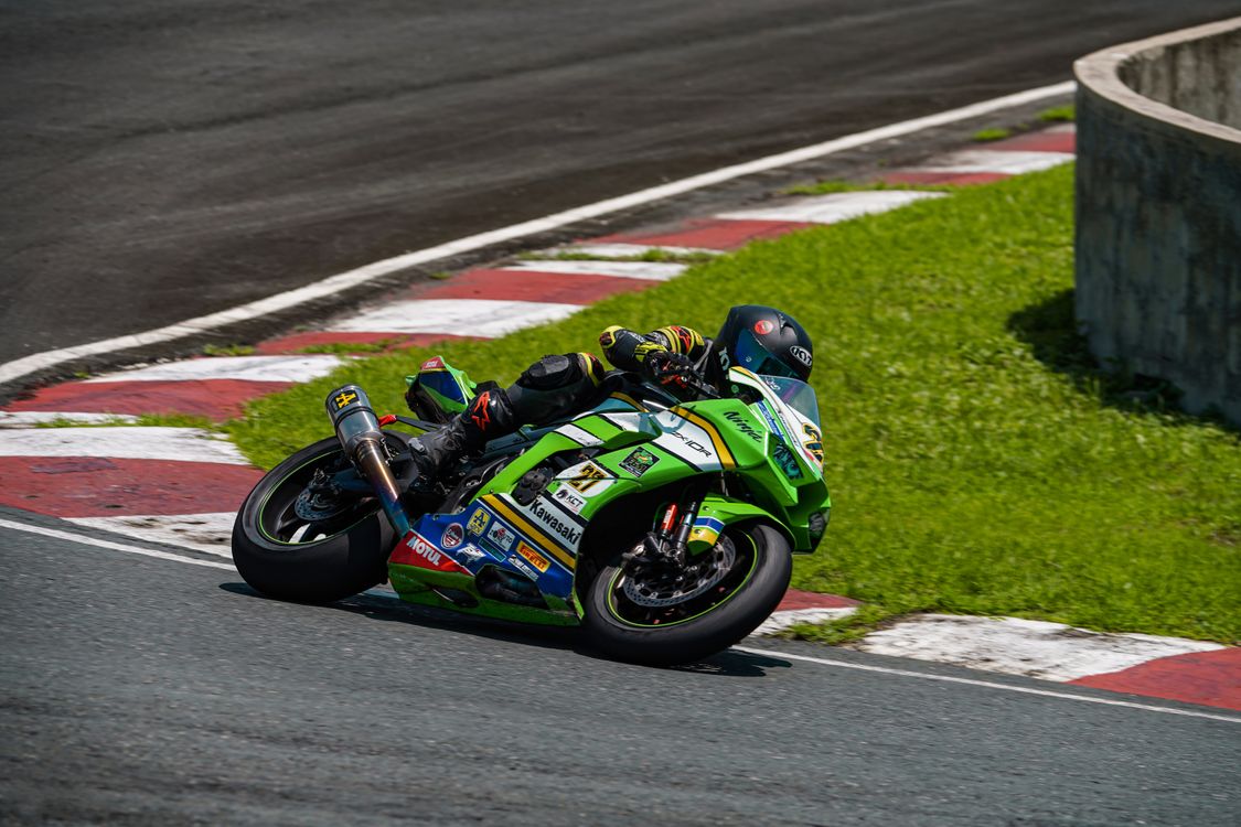 A person riding a motorcycle on a track · Free Stock Photo