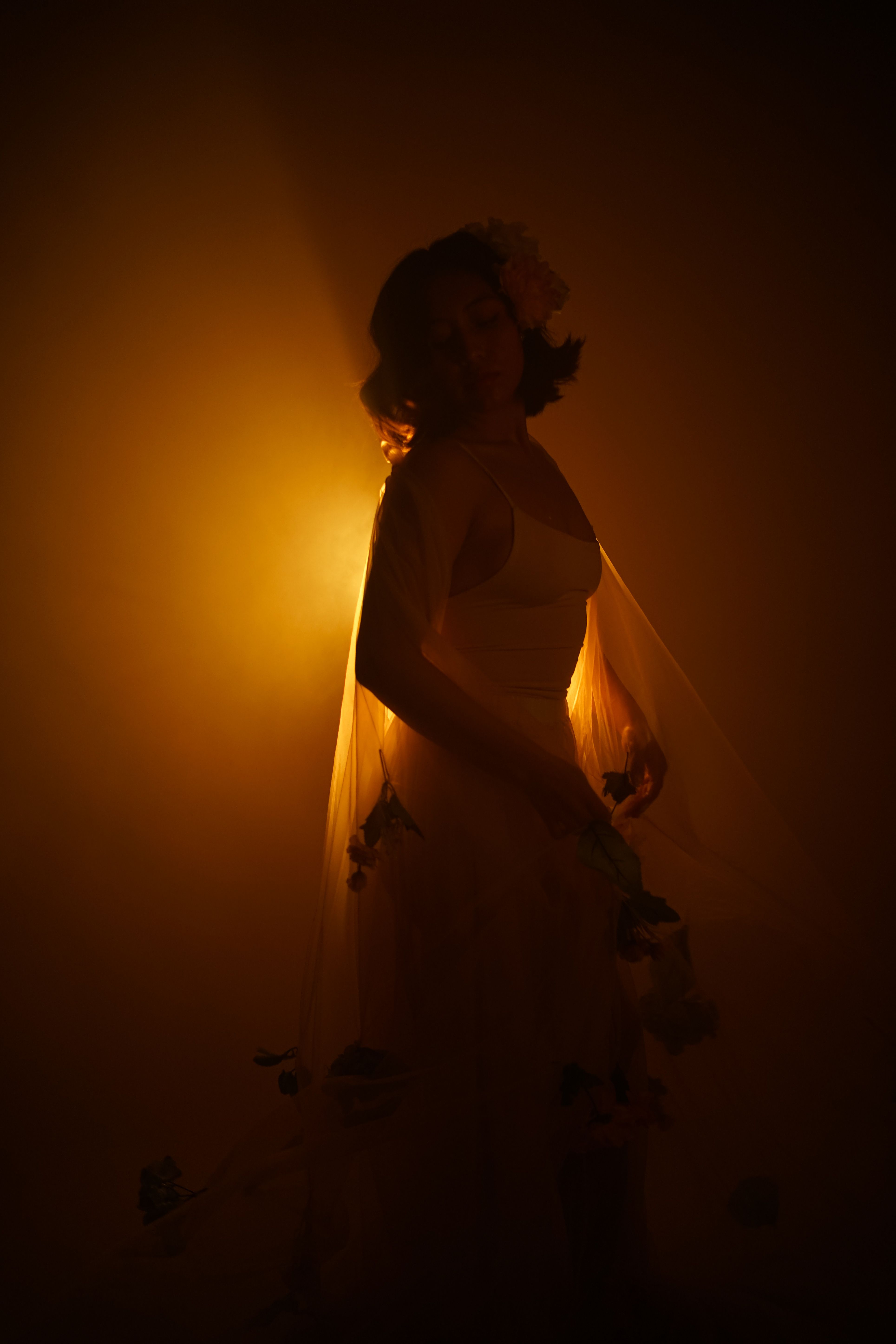 A woman in a wedding dress is standing in the dark · Free Stock Photo
