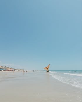 Explore the serene sands and vibrant waters of Canoa Quebrada beach on a sunny day.