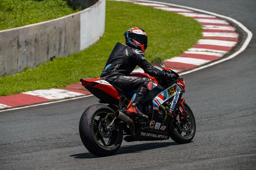 Free Motorcycle racer speeding on a track in Batangas, Philippines, showcasing skill and speed. Stock Photo