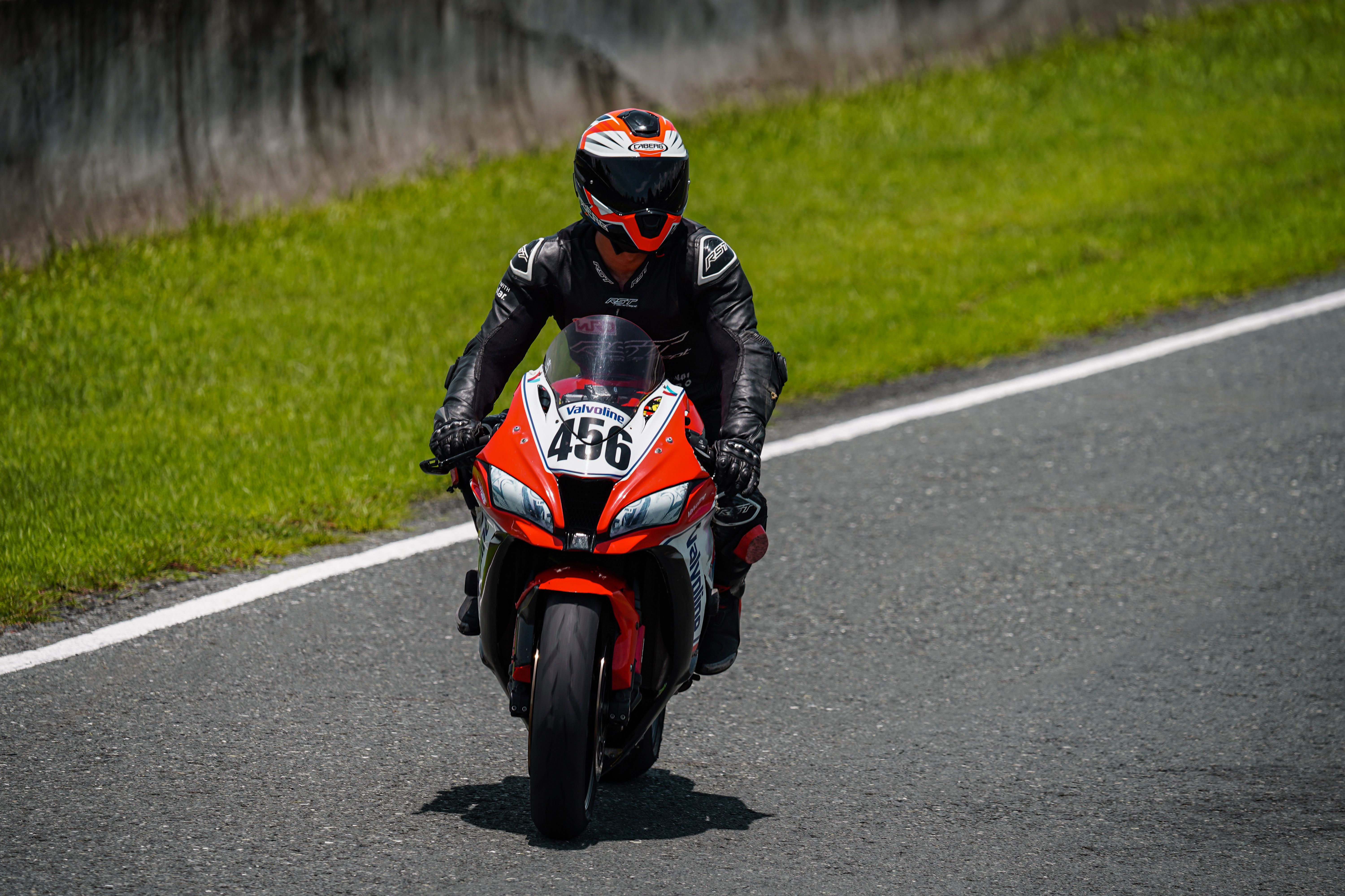 A person riding a motorcycle on a race track · Free Stock Photo