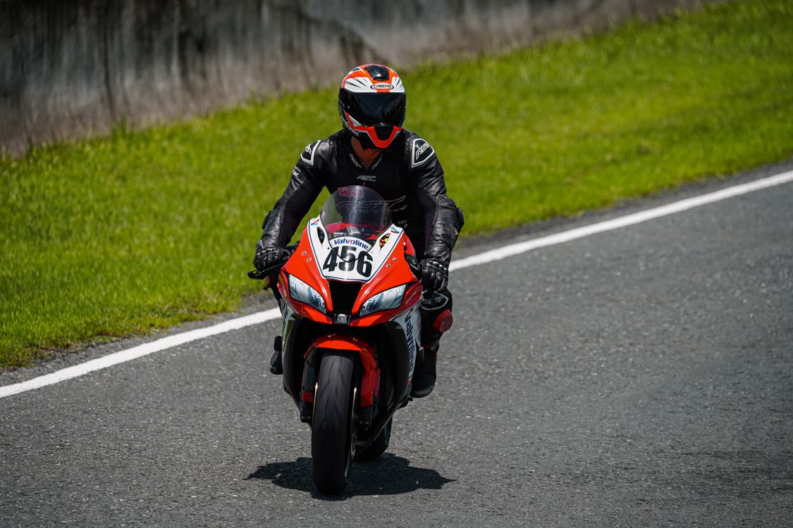 A person riding a motorcycle on a race track · Free Stock Photo
