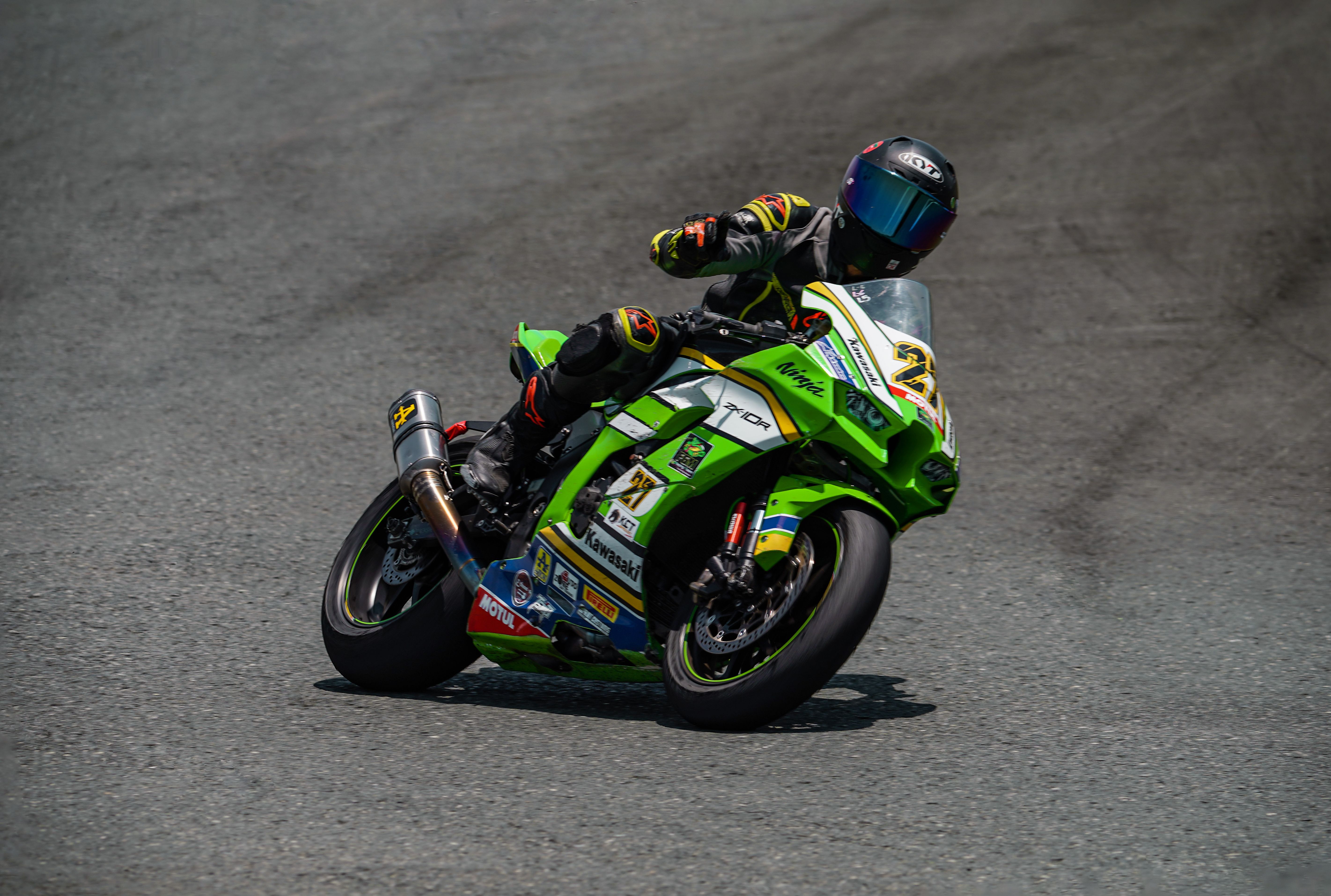 Motorcyclist taking a sharp turn on race track in Batangas. High-speed action and precision.