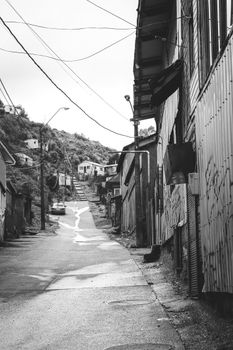 A black and white street view of Puerto Montt, capturing urban architecture and narrow roads.