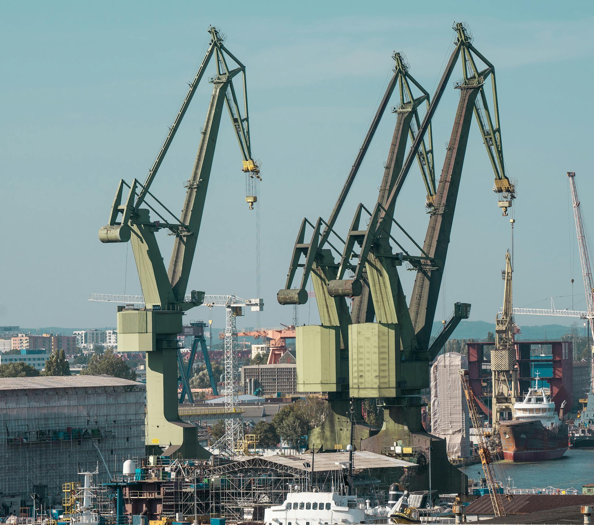 Aerial view of the bustling industrial shipyard with cranes in Gdańsk, Poland.