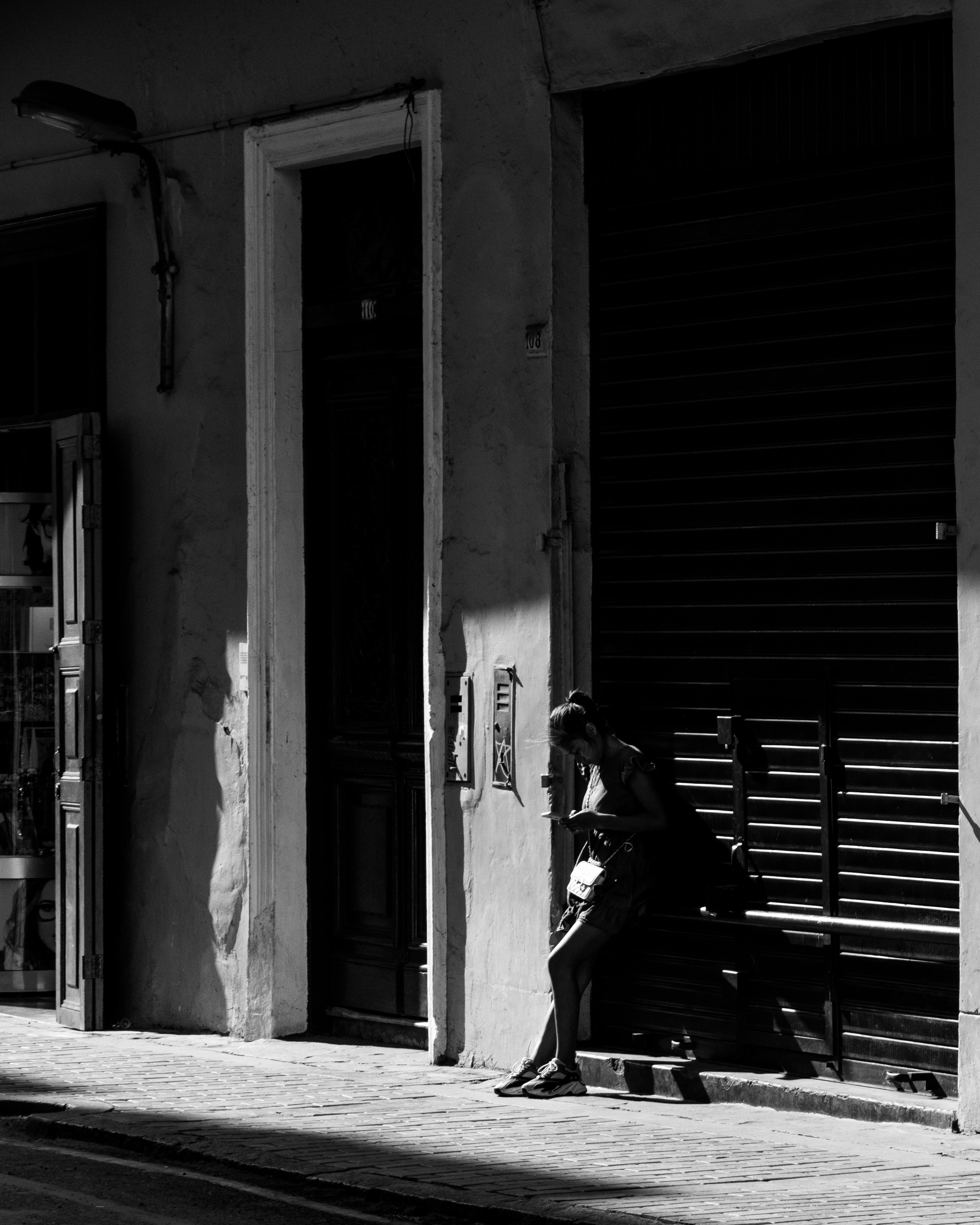 Moody black-and-white street photography capturing solitude and architecture.