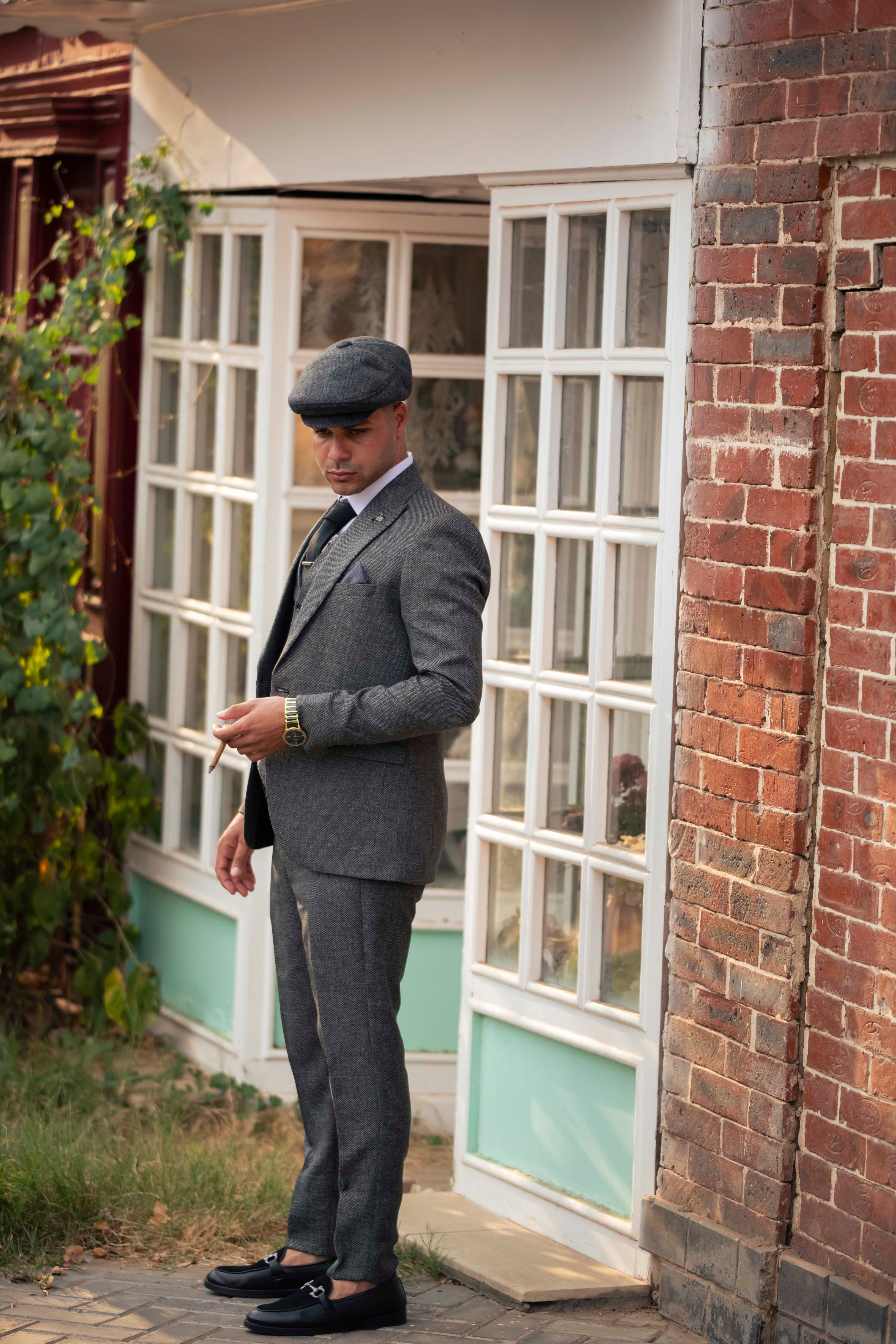 A man in a suit and hat is standing outside · Free Stock Photo