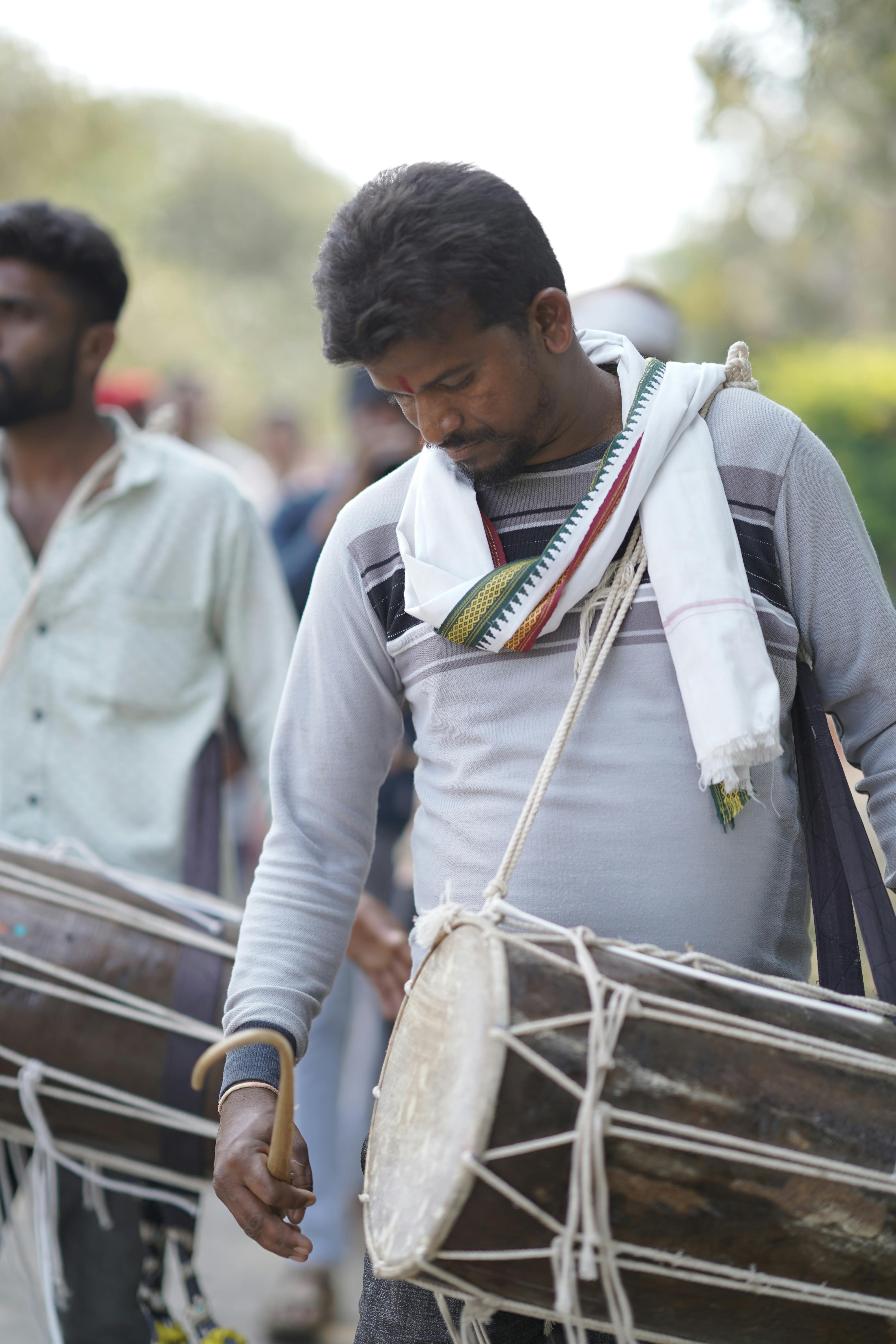 a man playing drums in the street