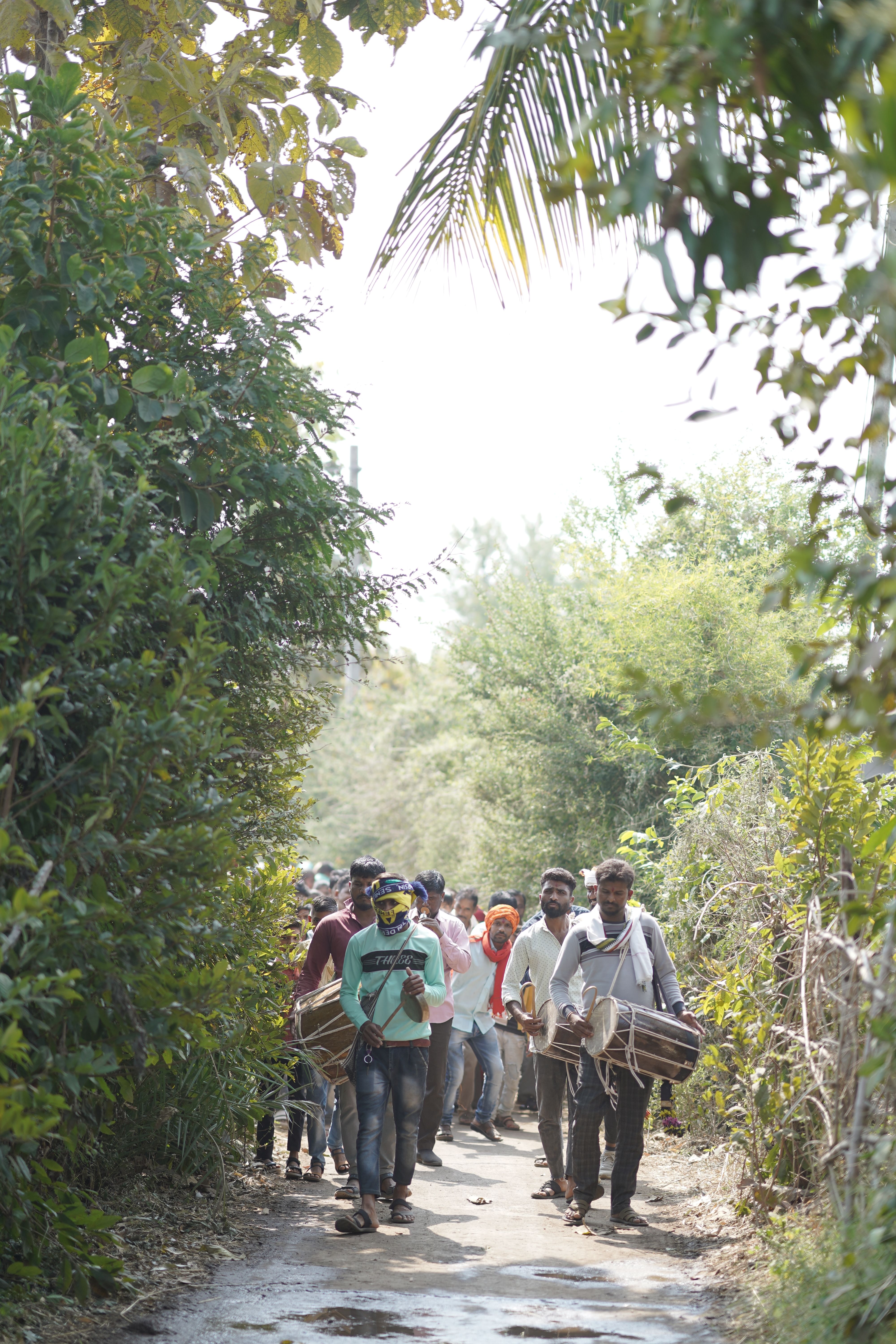 A group of people walking down a dirt road · Free Stock Photo