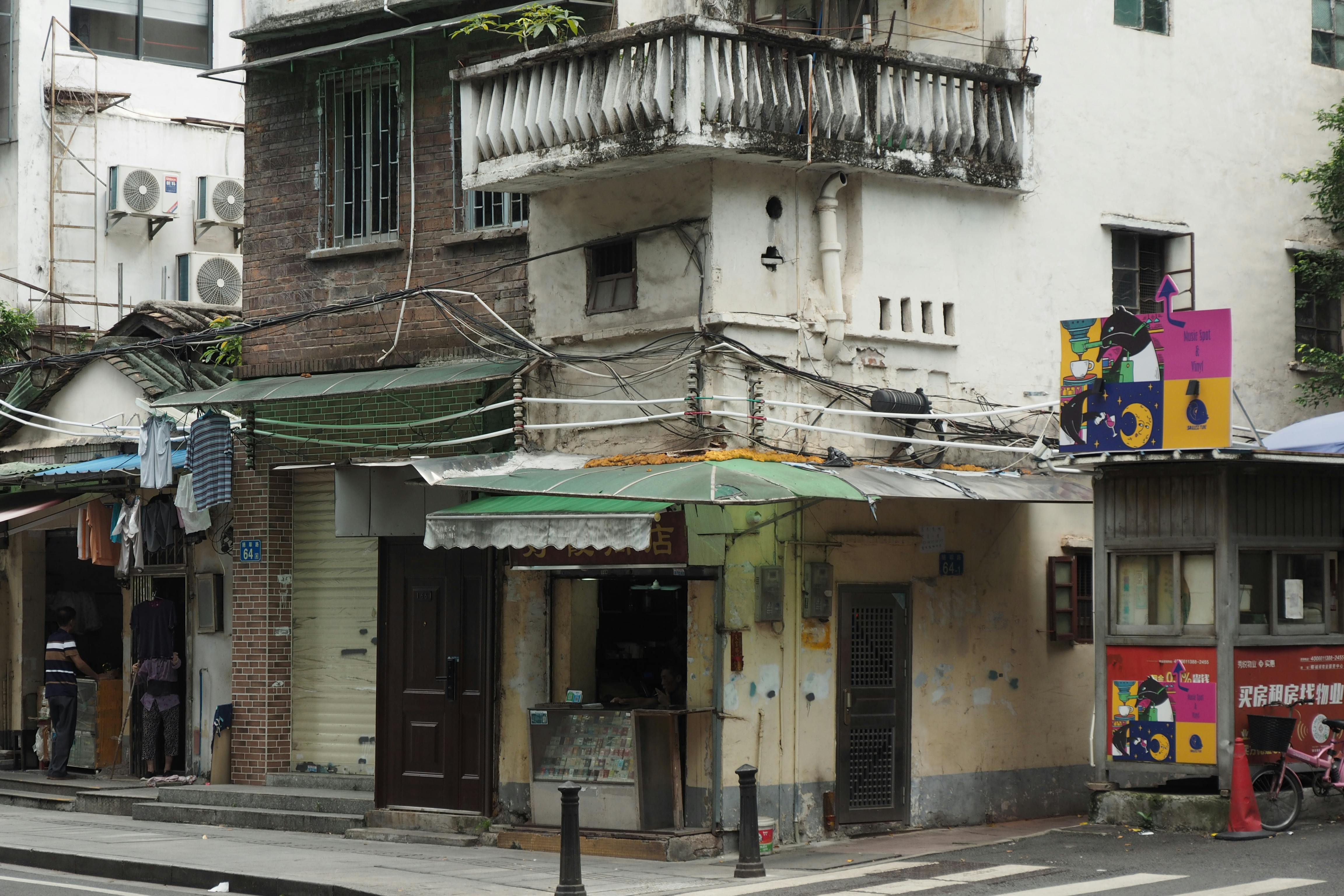 a street scene with a building and a motorcycle