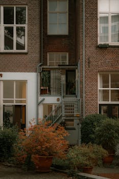 Autumn courtyard in Amsterdam with warm tones and urban details.