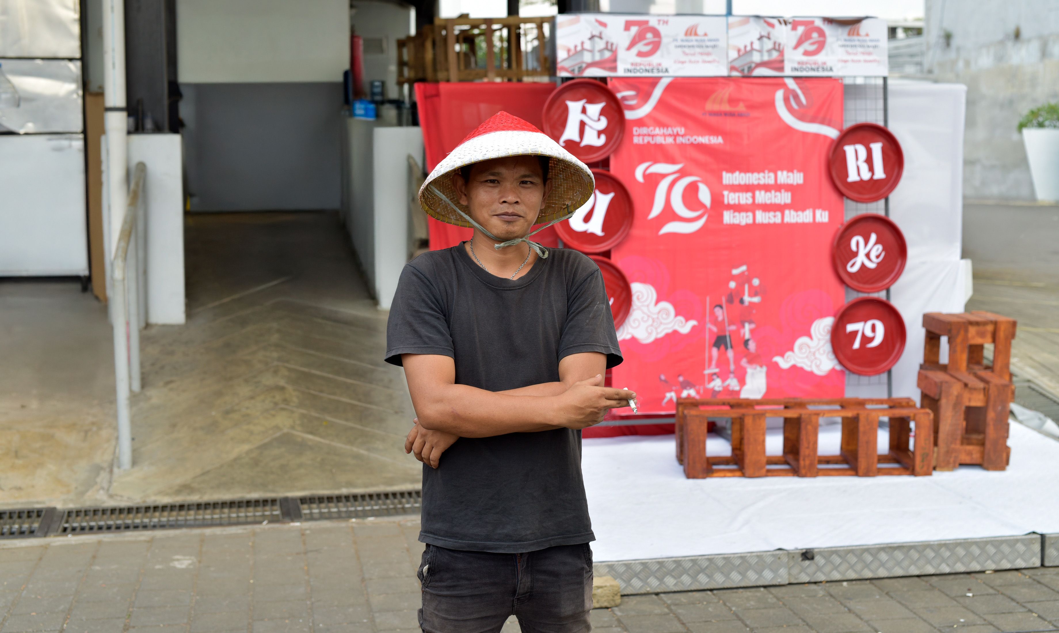 A man standing in front of a building with a red sign · Free Stock Photo