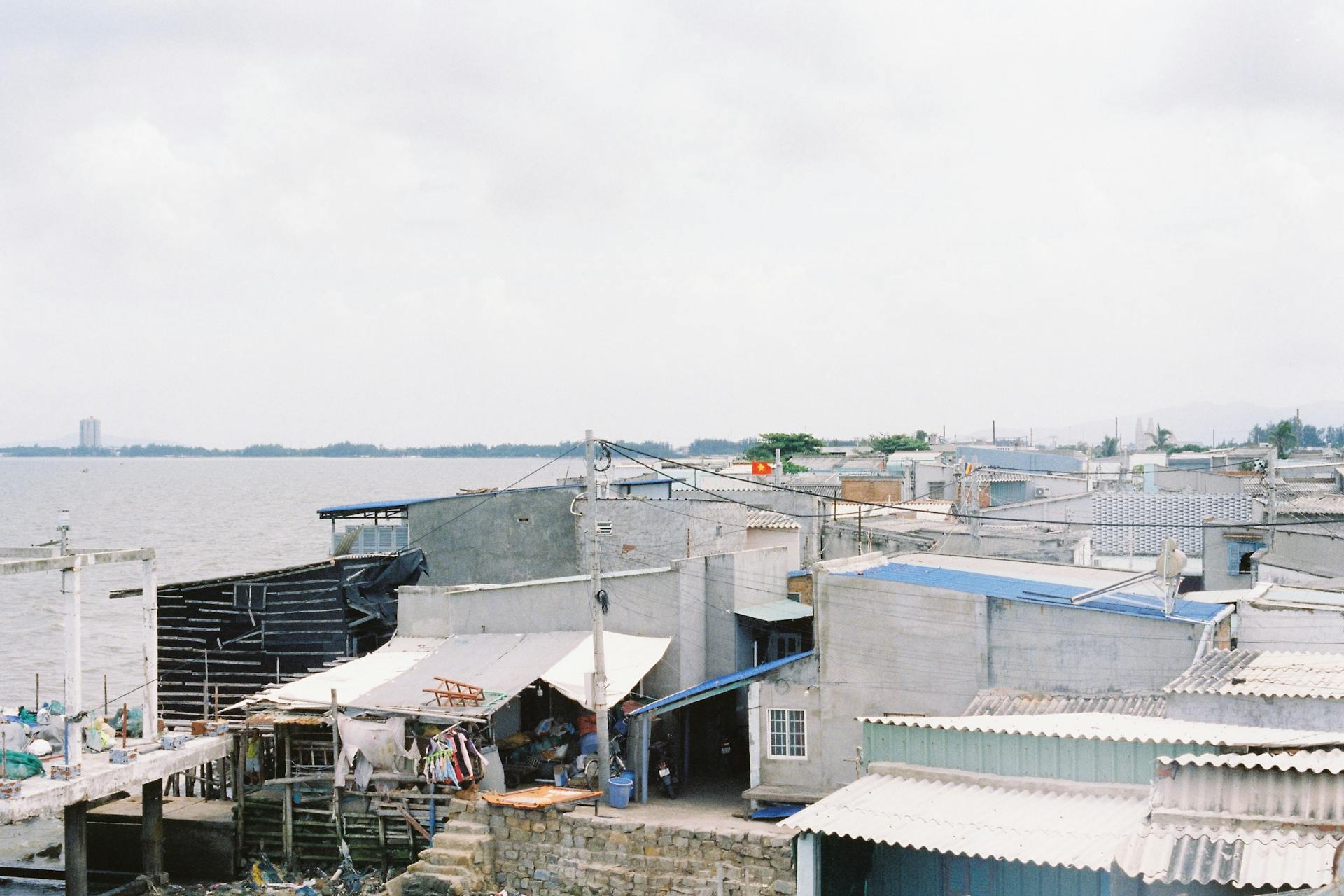 Rustic coastal village scene in Ba Ria, showcasing seaside buildings and calm waters.