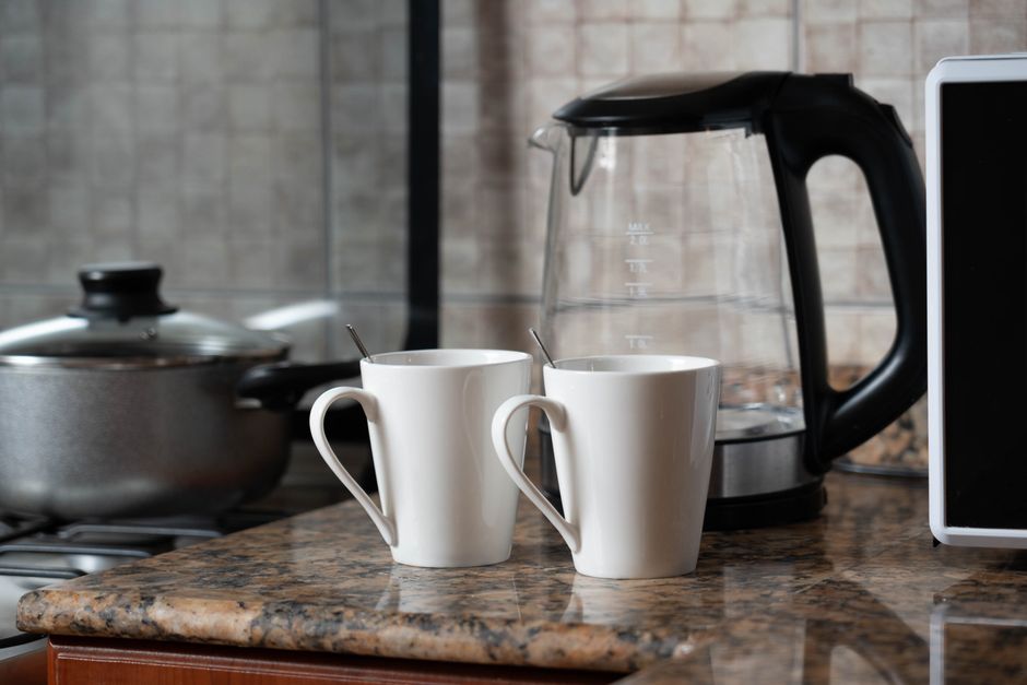 kitchen counter, bedroom dresser, or entry table at home coffee mug phone keys lifestyle photo 2