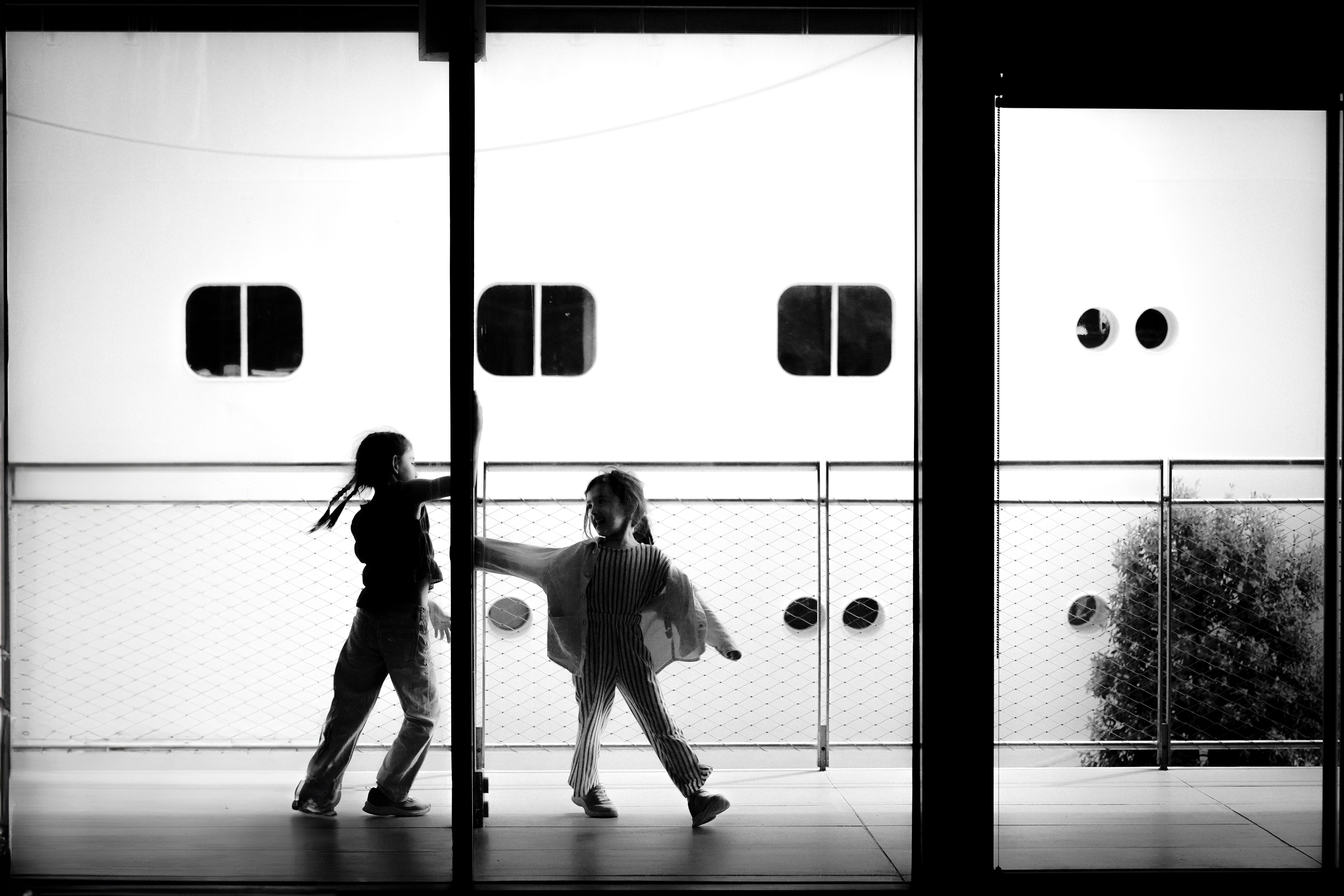 Two people are walking through a glass door · Free Stock Photo