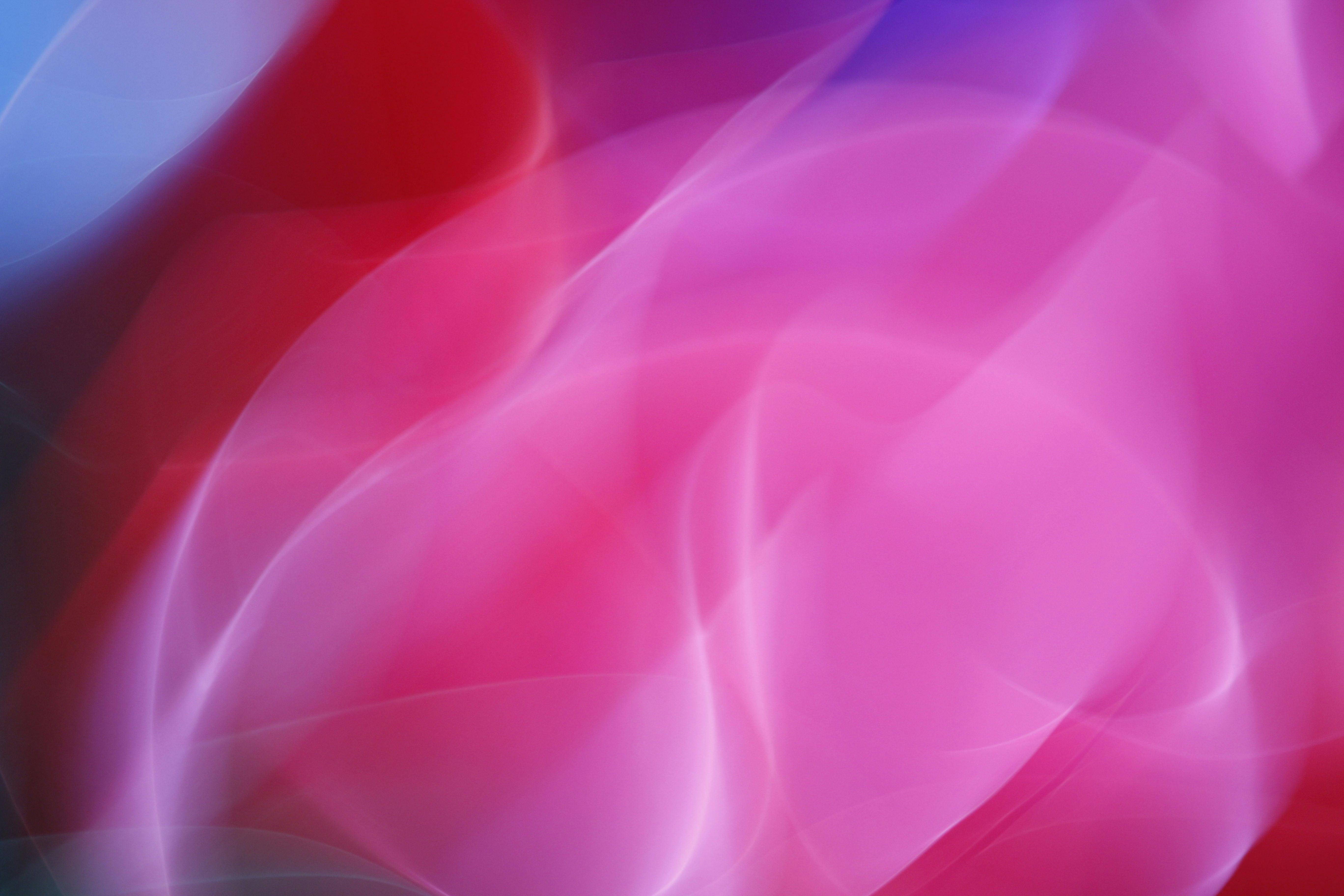 a pink and blue abstract background with a red and blue swirl