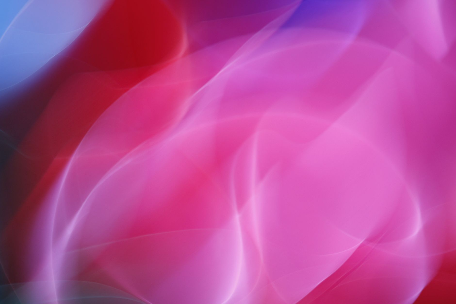 Dynamic abstract image with smooth gradients in pink and red hues, ideal for vibrant design projects.