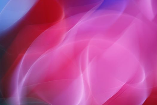 Dynamic abstract image with smooth gradients in pink and red hues, ideal for vibrant design projects.
