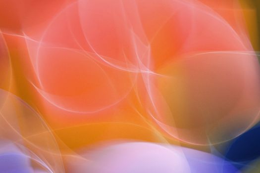 Dynamic abstract image featuring vibrant light swirls with a gradient of red, orange, and purple hues.