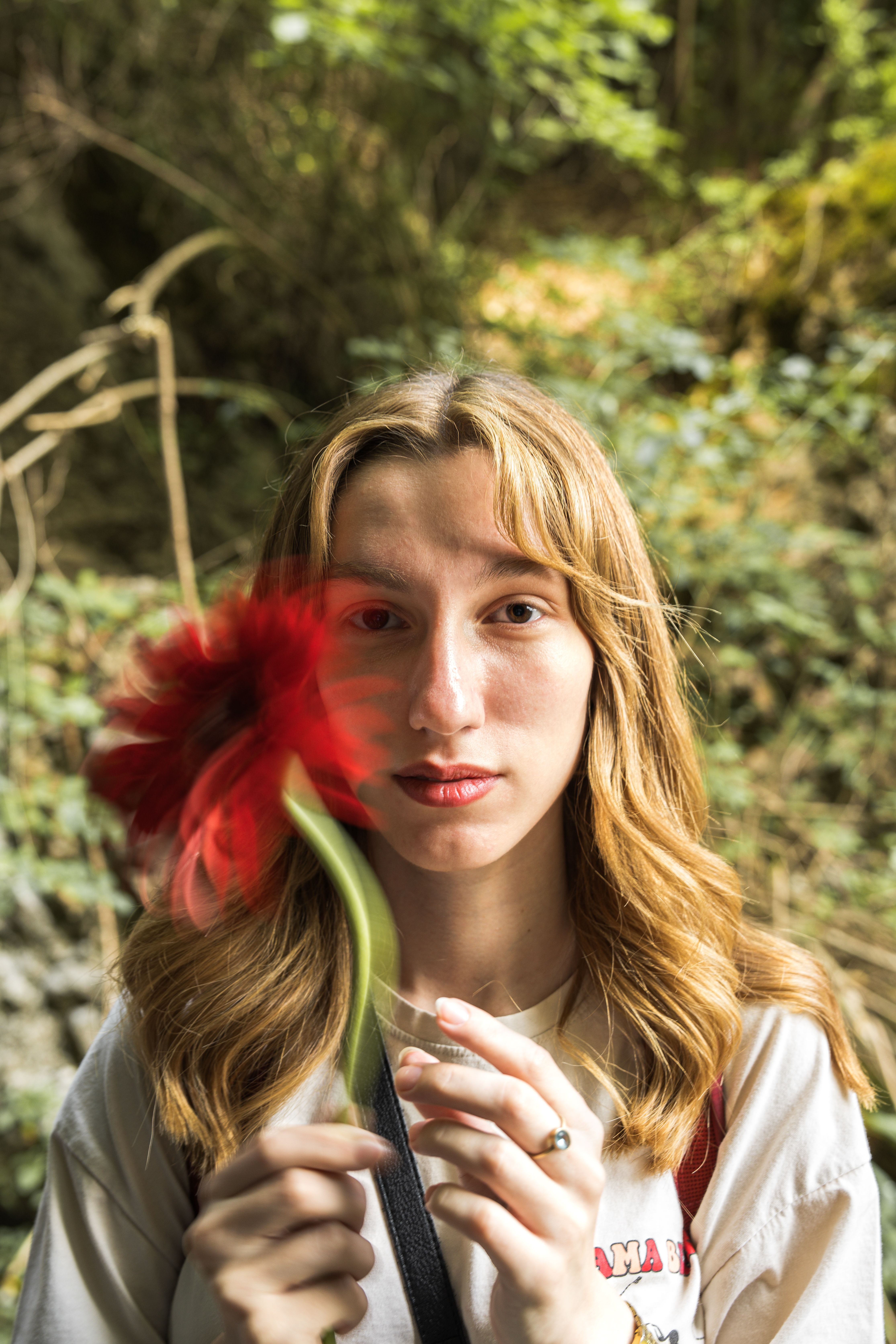 A woman holding a flower in her hand · Free Stock Photo