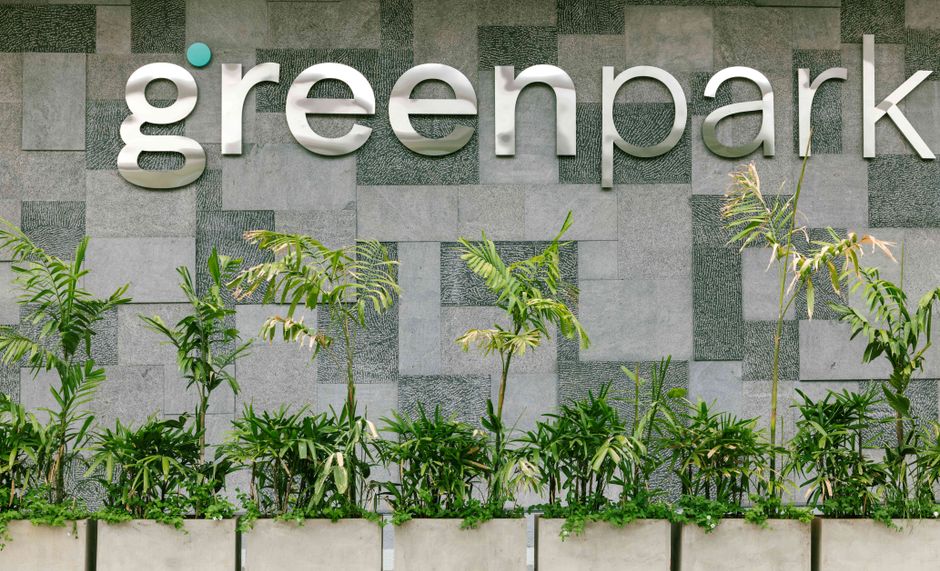 Modern exterior sign and plants at Green Park Hotel in Bengaluru.