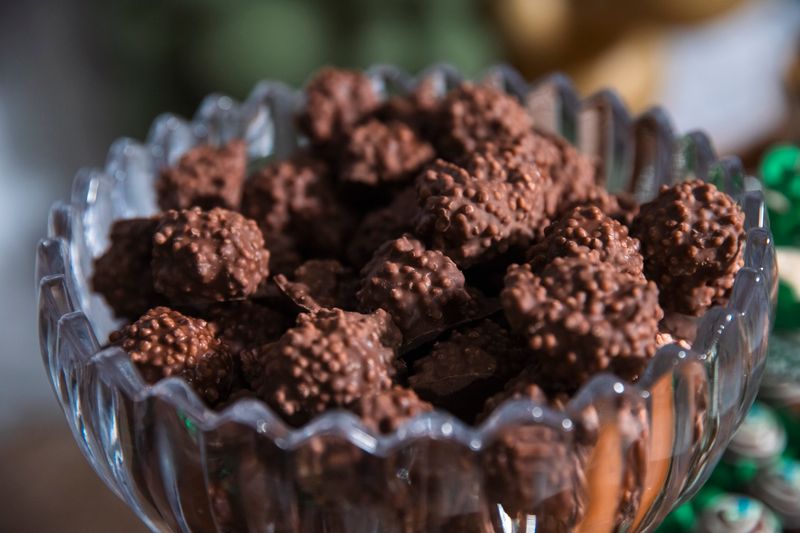 pretzel rods dipped in chocolate with sprinkles