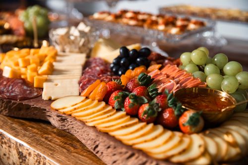 Free Elegant cheese and charcuterie board with fresh fruits and gourmet selection. Stock Photo