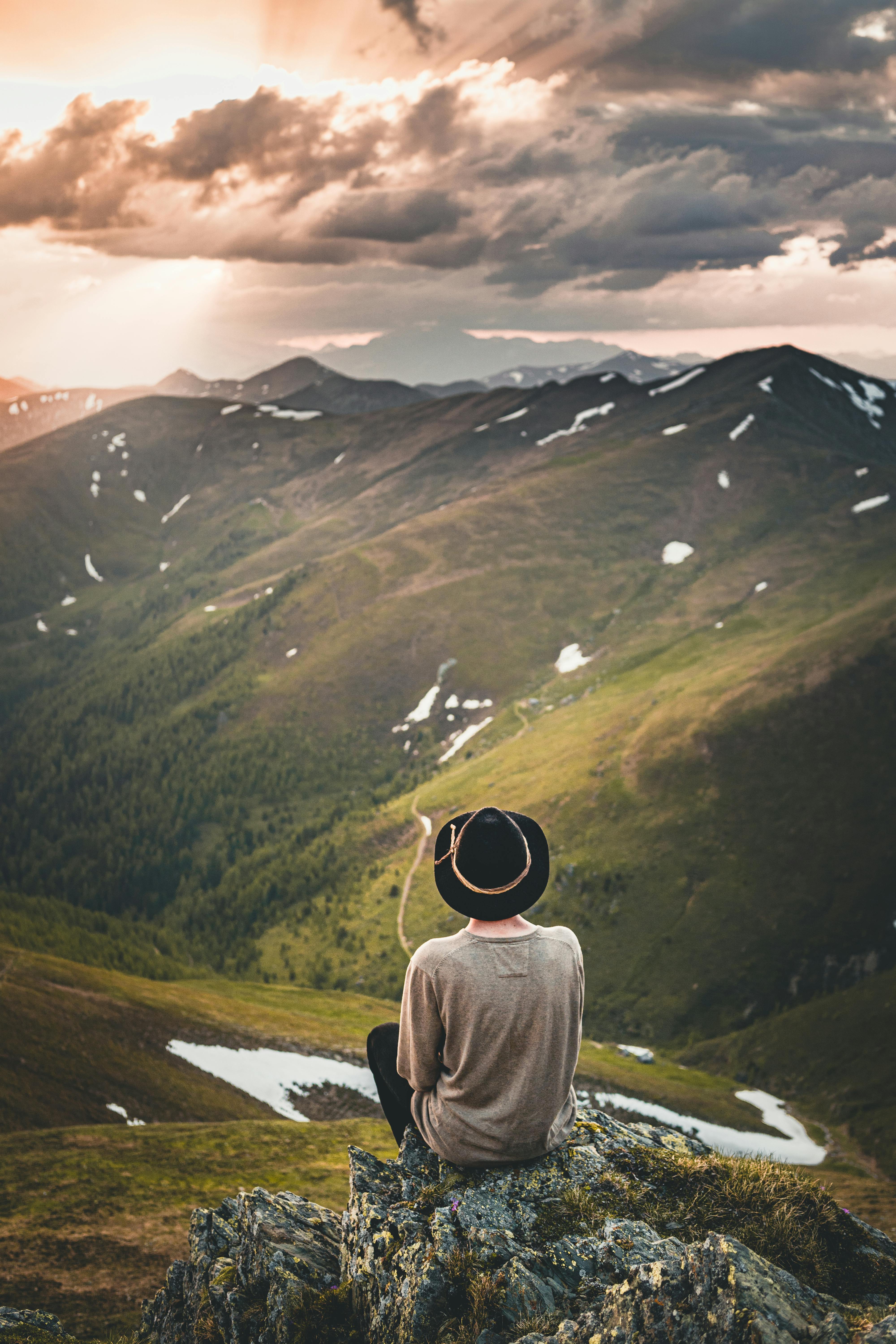 Free Person in Gray Top Sitting on Rock The Flower of Patience