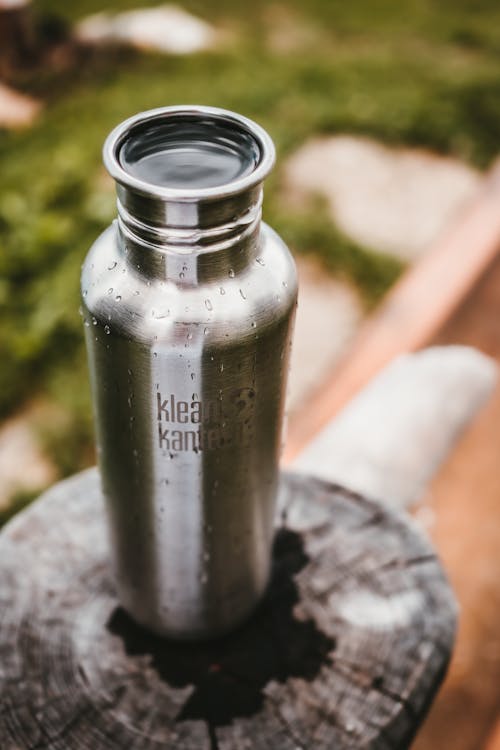 Silver Bottle on Gray Surface