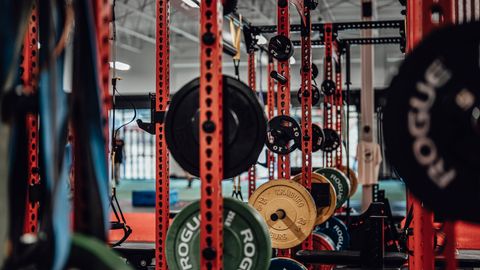 A well-equipped gym with various weightlifting gear and exercise equipment.