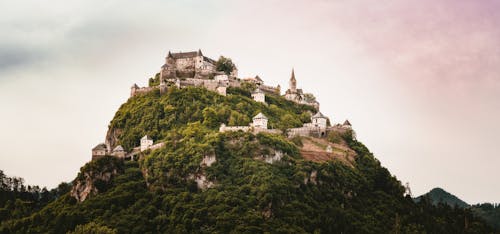 Free A Beautiful Castle Built On Top Of A  Mountain Surrounded By Trees Stock Photo