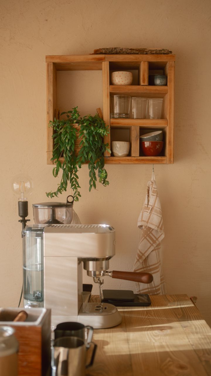 small hanging macrame planters above a corner coffee bar with trailing plants