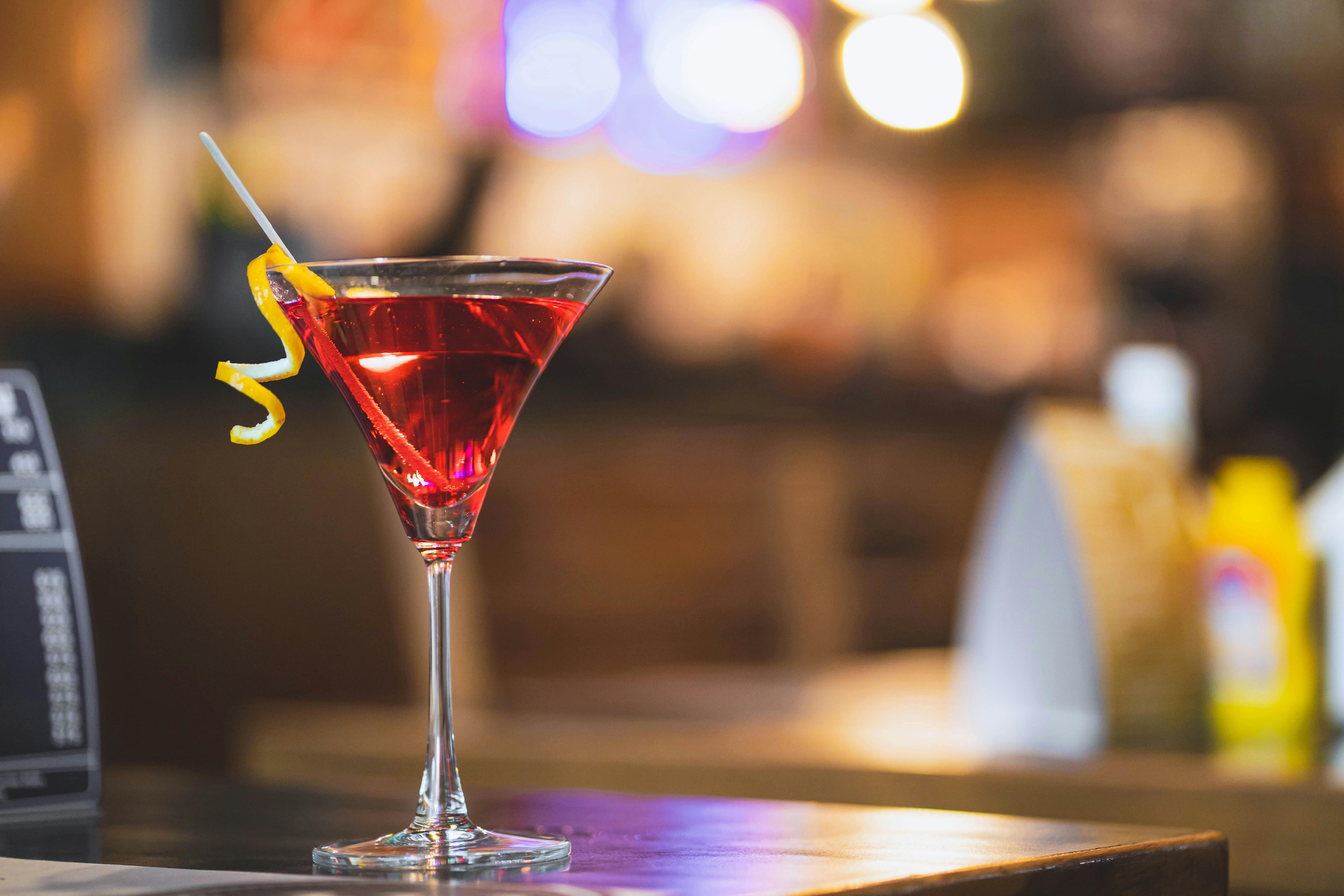 cocktail topped with lime slice single glass of dry martini