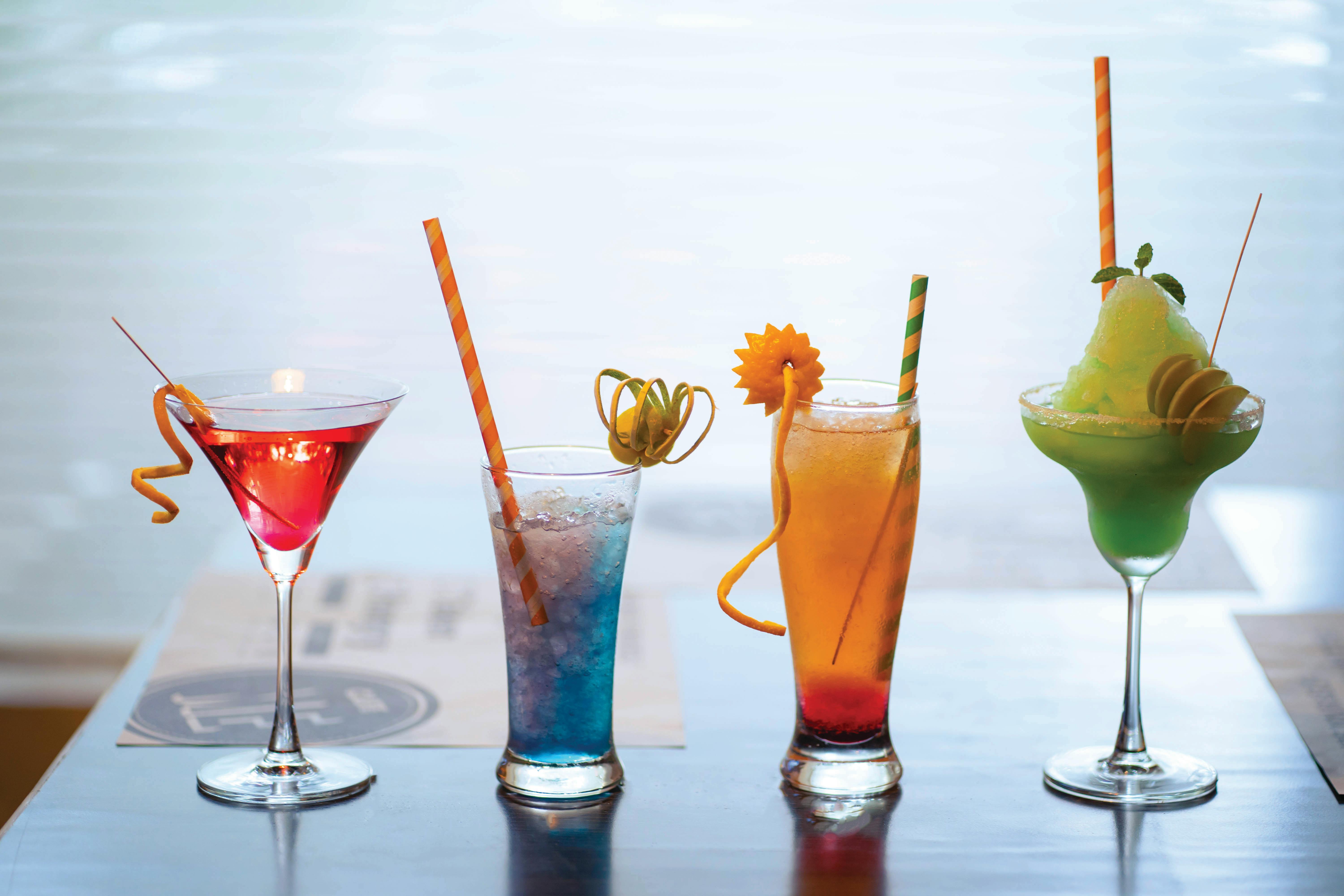 a set of summer cold drinks in glasses on a black background