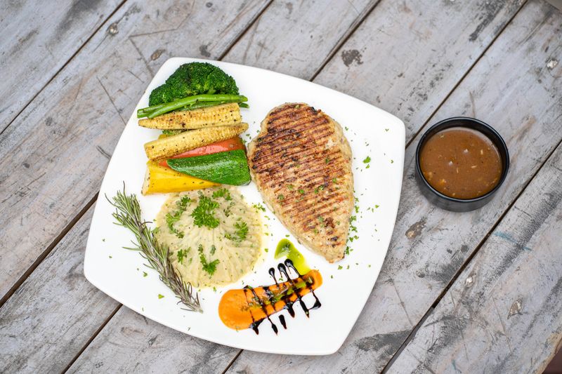 Grilled chicken breast plated with roasted vegetables and whipped potato — photo by ajit shahu on Pexels