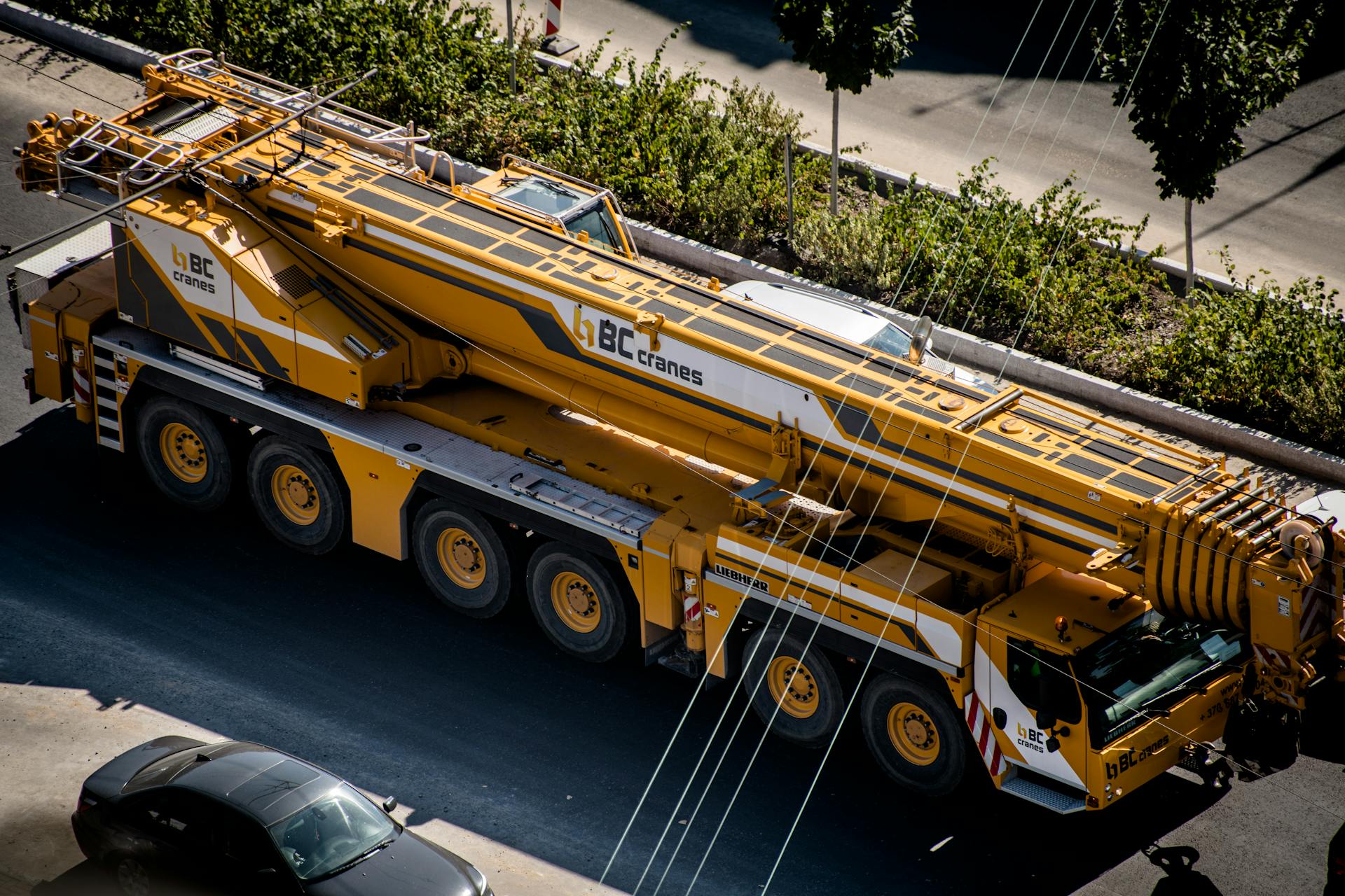 A mobile crane parked on an urban street in Vilnius, Lithuania.