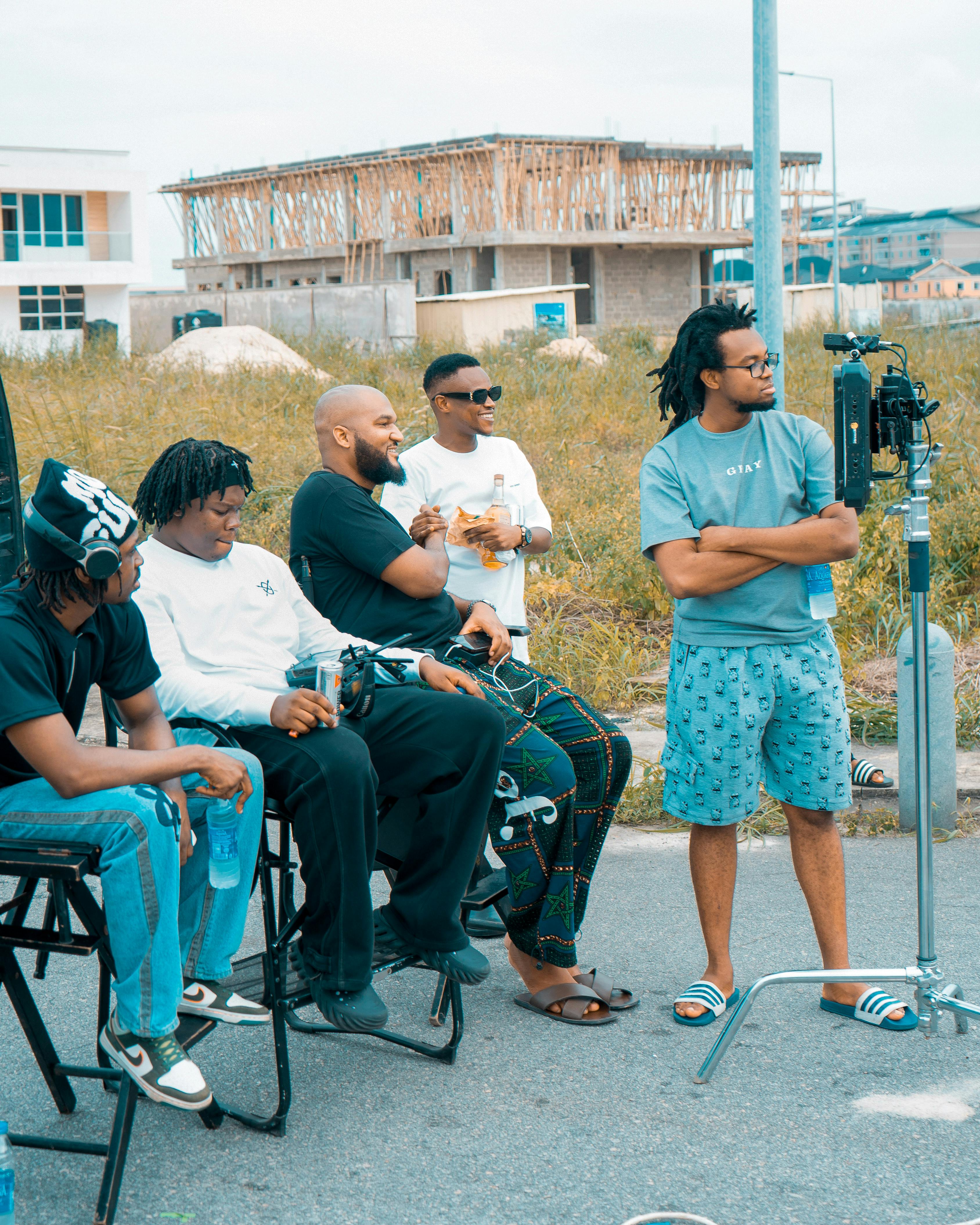 a group of men sitting on chairs and talking