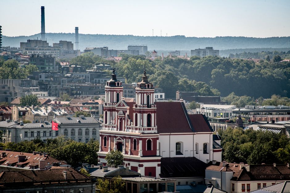 Aerial view of St. Catherine's Church amidst Vilnius cityscape on a sunny day.